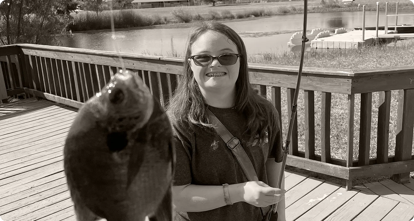 A camper holding a fish