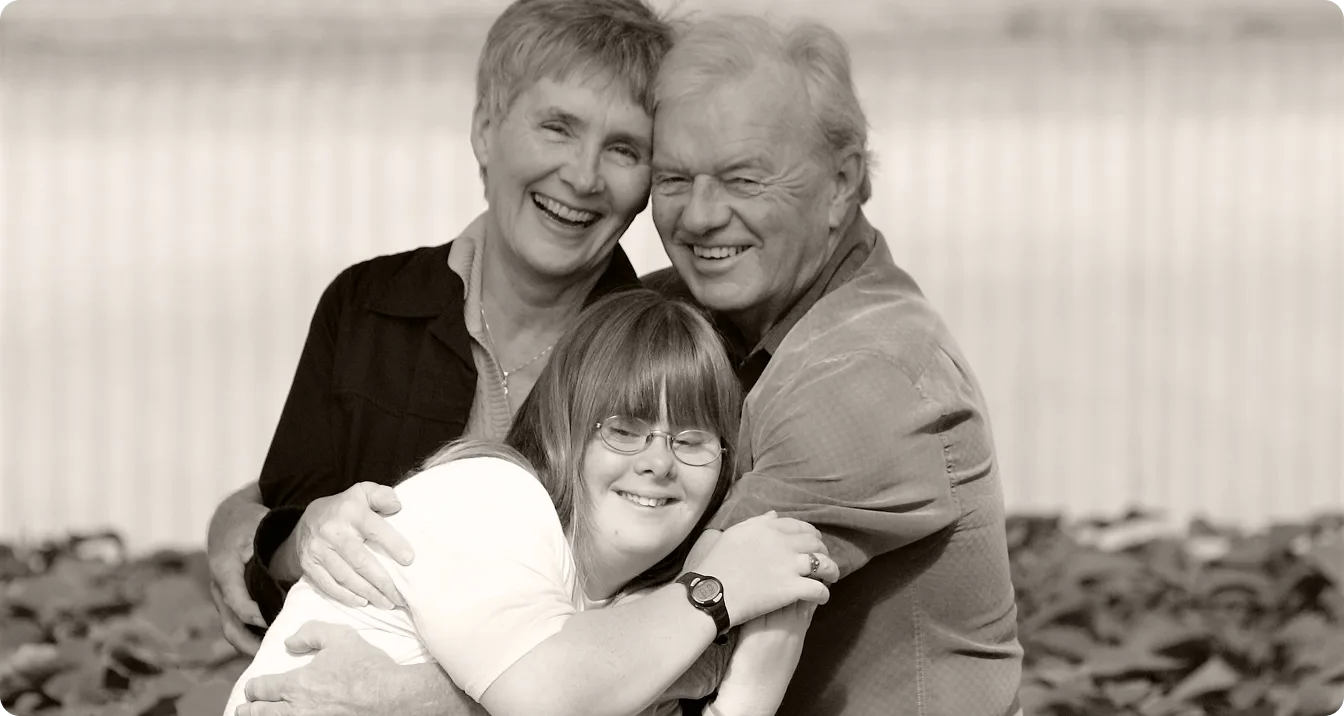A camper hugging her parents.